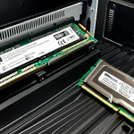 A side-by-side comparison of computer RAM modules: on the left, a large, robust desktop DIMM (DDR4) with a prominent, metallic heatsink, standing within a spacious, well-ventilated desktop PC case, emphasizing its size and ample space. On the right, a significantly smaller, compact laptop SO-DIMM (DDR4), nestled tightly within the cramped, intricate interior of a thin, open laptop chassis, highlighting miniaturization and limited space. Clear distinction in physical dimensions and their respective environments.